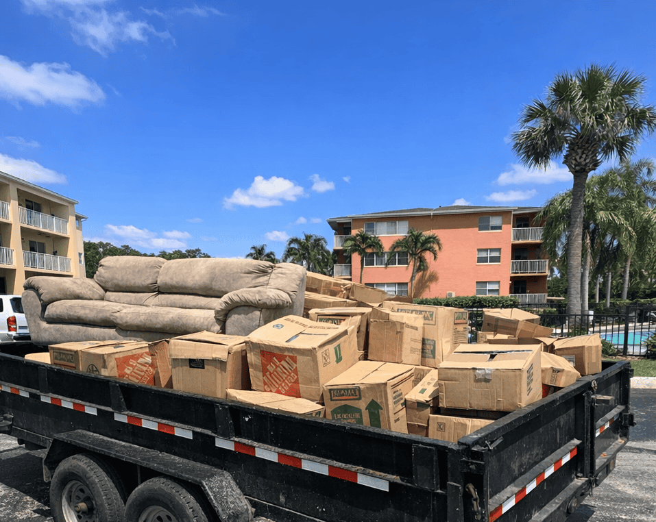 On-Call Hauler dump trailer loaded with furniture and boxes during a move-out cleanout in Palm Beach County